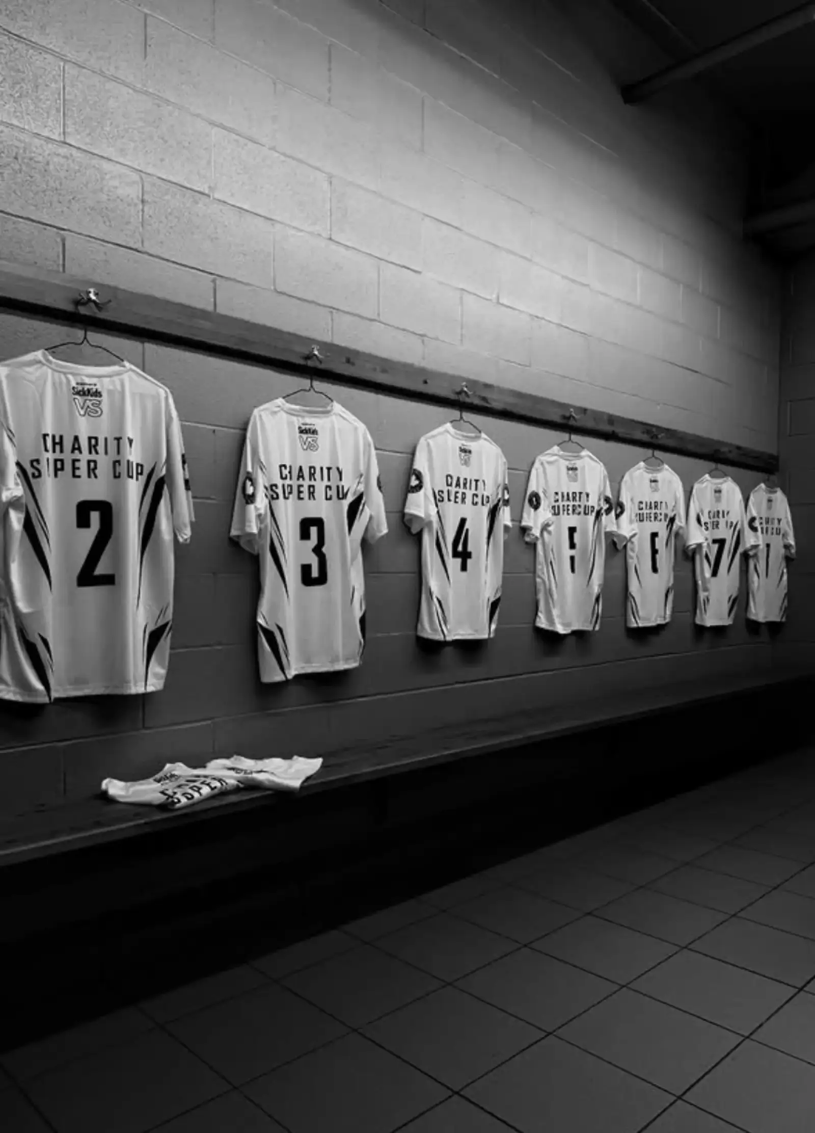 Charity Super Cup jerseys hanging in the locker room