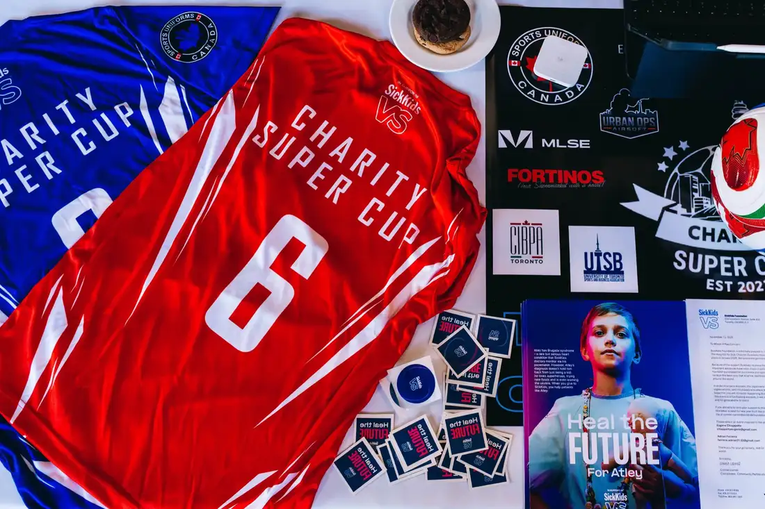 Charity Super Cup jerseys and sponsor materials laid out together