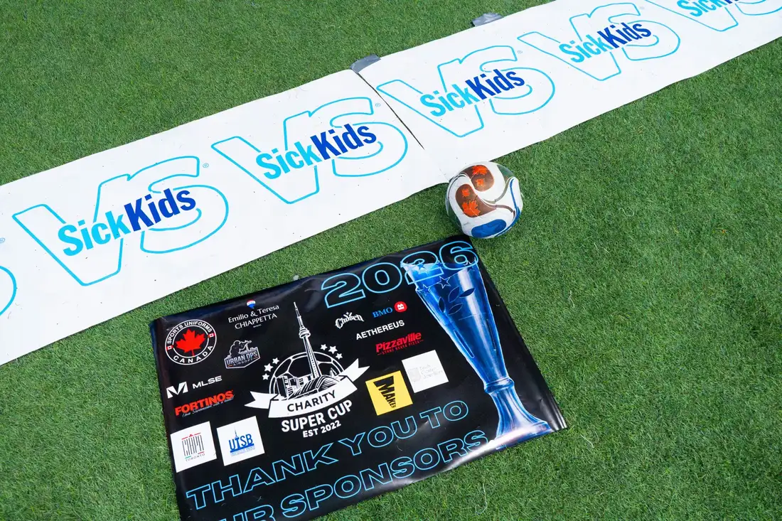 Sponsor banner and match ball on the turf