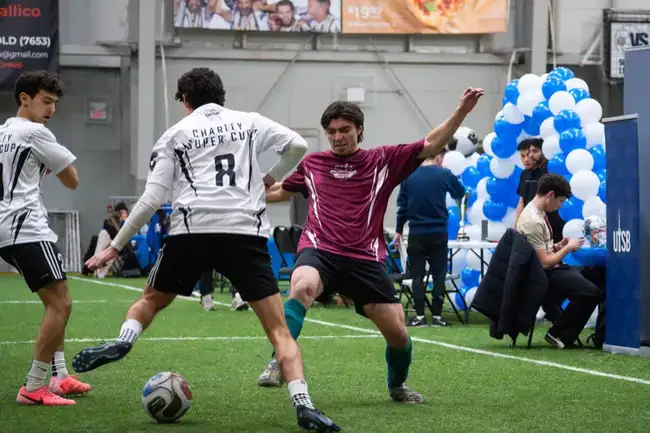 Players challenging for the ball on the pitch