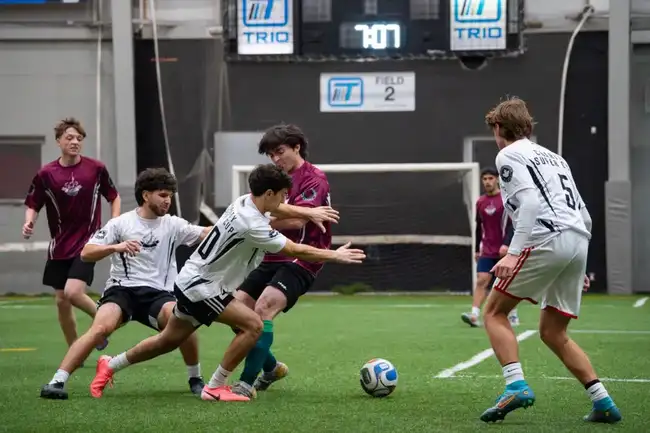 Players competing for the ball on the pitch