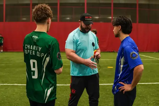 Referee speaking with two players