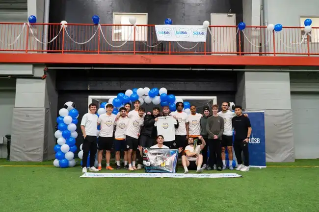 Full team group photo with the SickKids banner