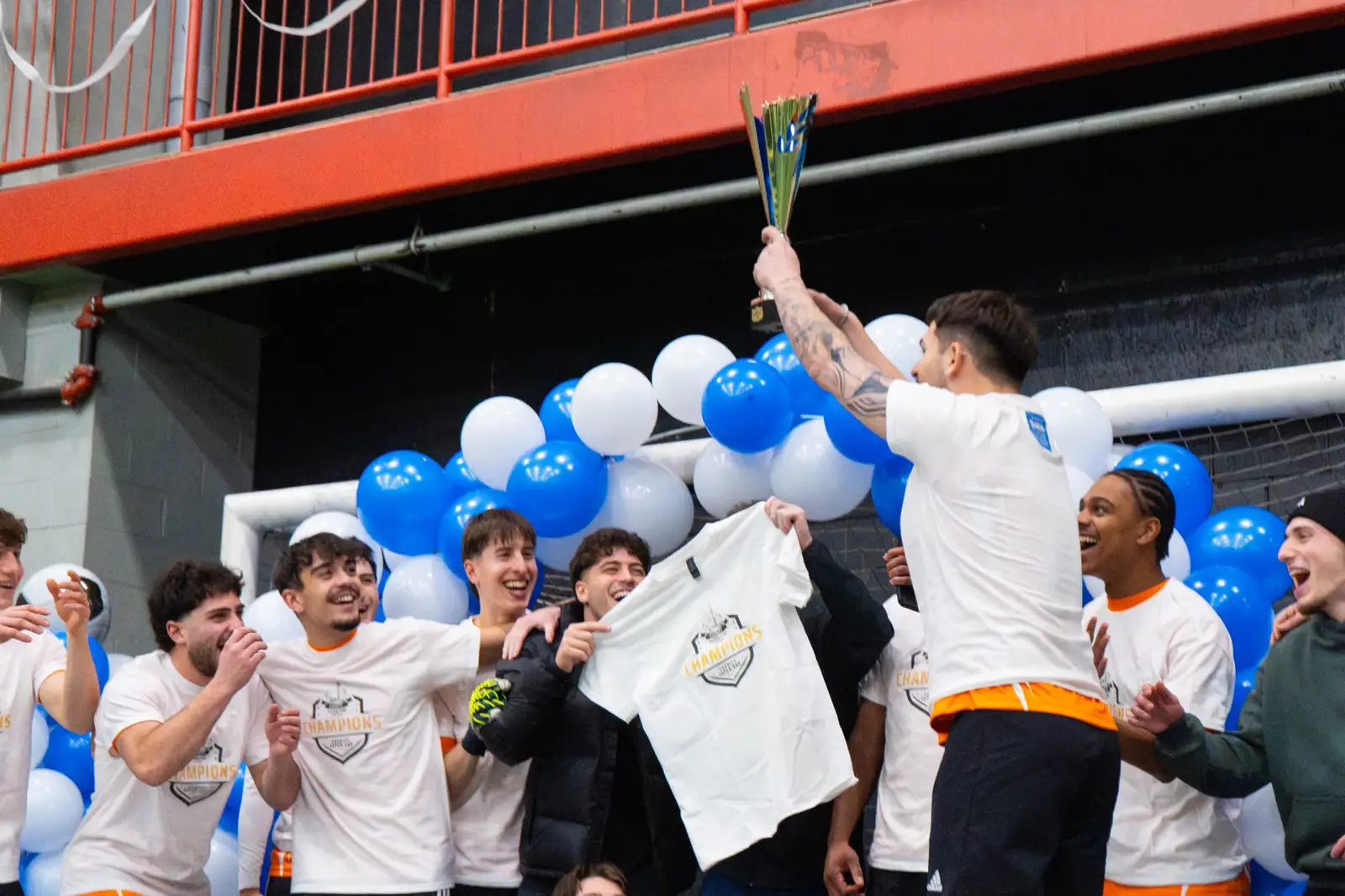 Charity Super Cup champions raising the trophy overhead in celebration
